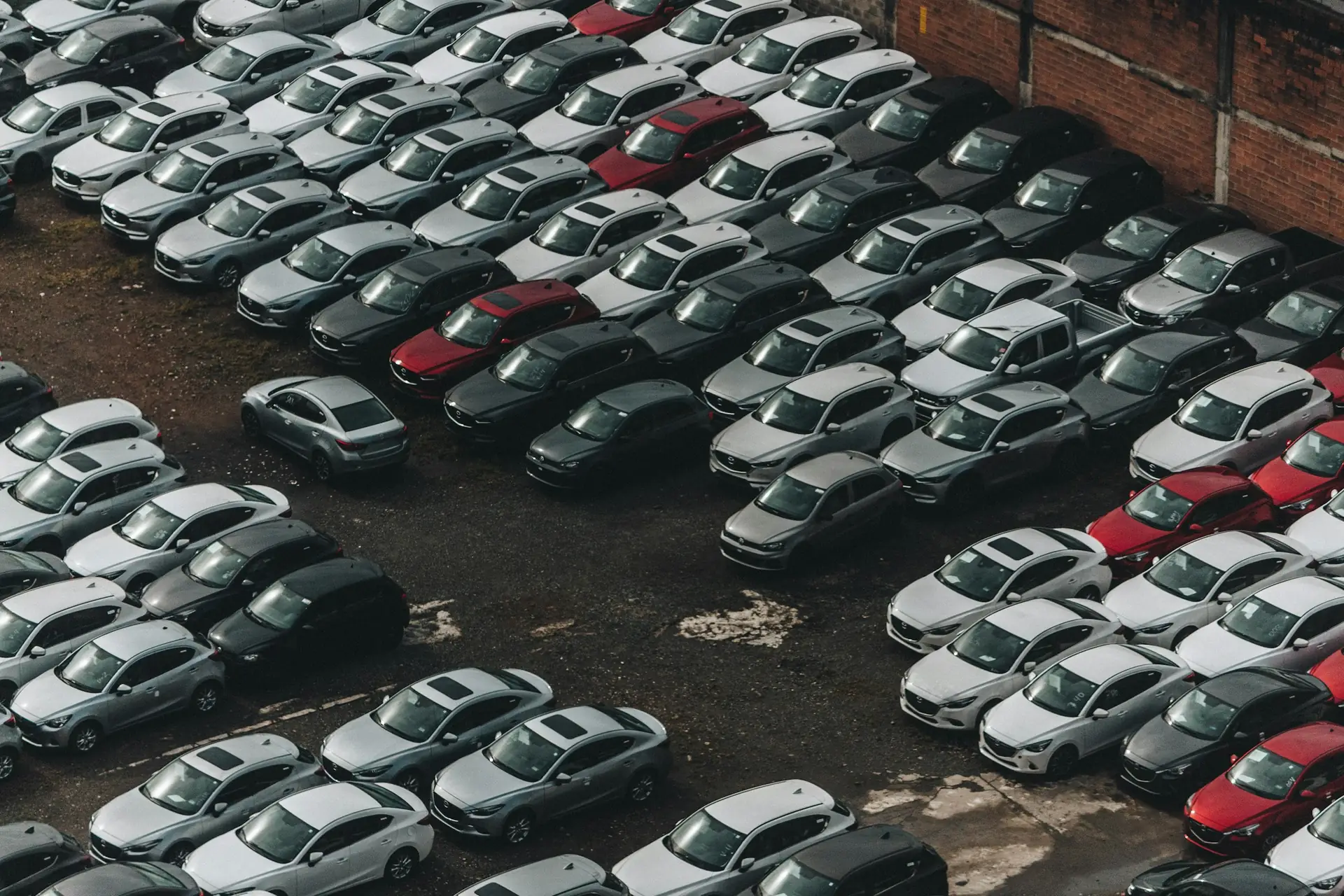 Rows of used cars parked on a lot, seen from above