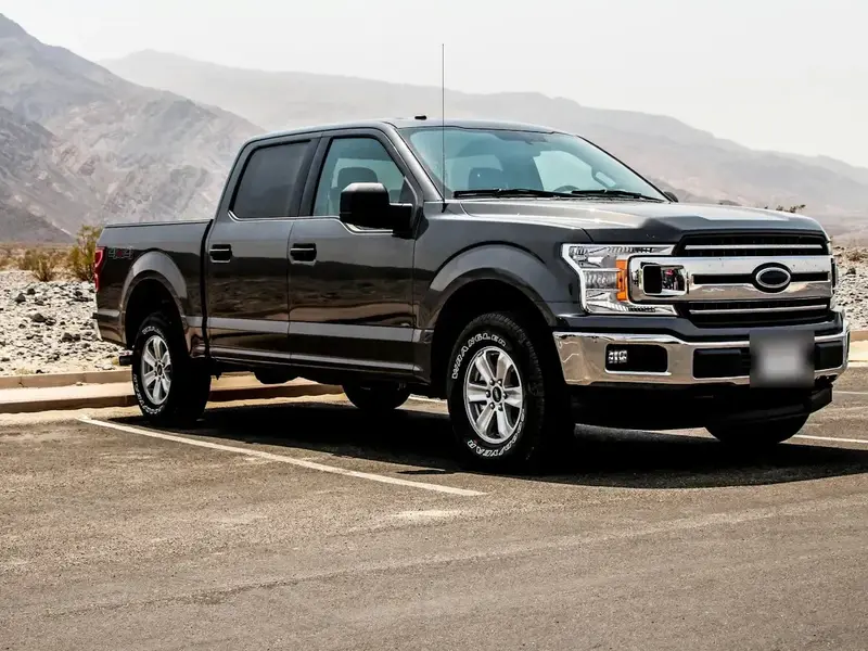Dark grey Ford F-150 crew cab in a parking lot